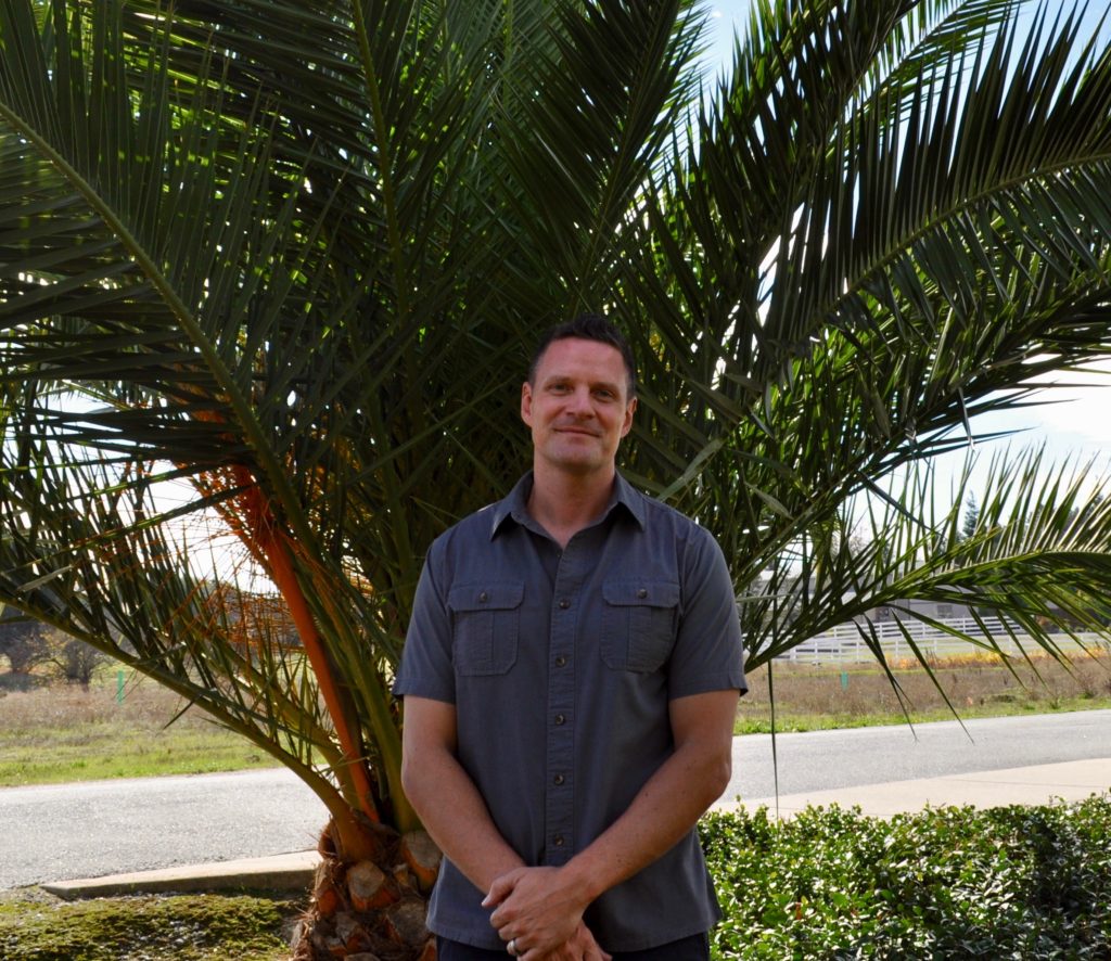 Jeff Schmidt in front of a palm tree